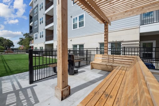 spacious patio with a wooden bench