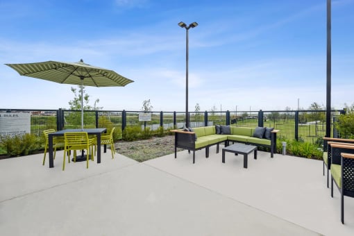 a patio with a table and chairs and an umbrella