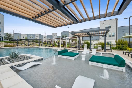a resort style pool with lounge chairs and a pergola