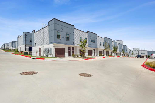 a street view of a row of new apartment buildings