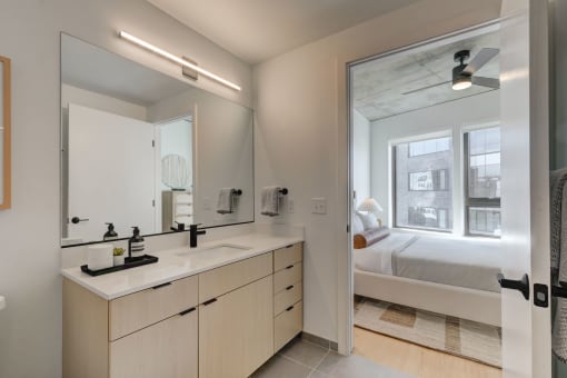 a bathroom with a large mirror and a sink