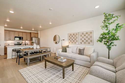 A living room with a couch, coffee table, and a potted plant.