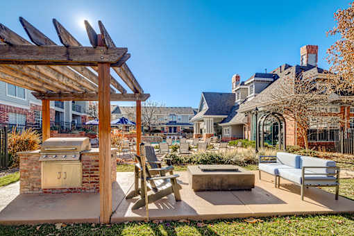 Outdoor lounge with grills at The Retreat at Fox Hollow apartments for rent in Lakewood, CO.