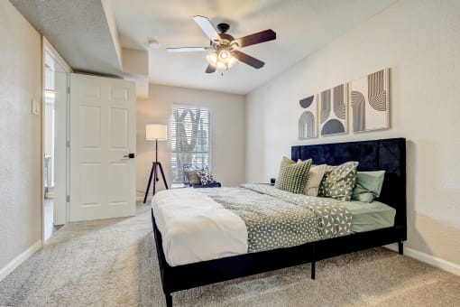 a bedroom with a bed and a ceiling fan