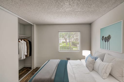 a bedroom with a large bed and a window
