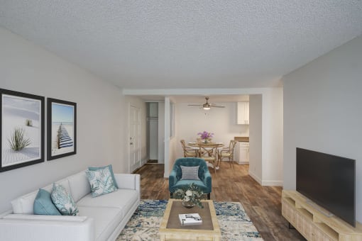 a living room with a couch and a chair and a tv