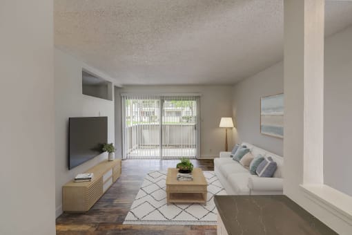 a living room with a white couch and a television