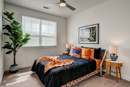 a bedroom with a bed and a ceiling fan