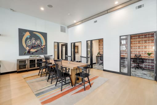 a dining room with a wooden table and chairs