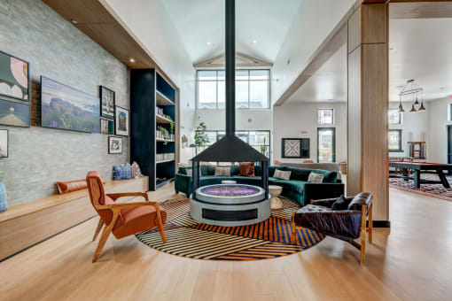 a living room with a round table and a fireplace