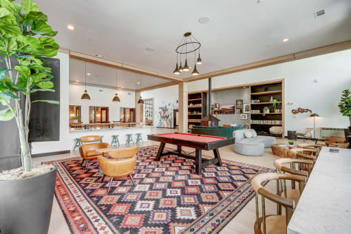 a living room with a ping pong table and other furniture