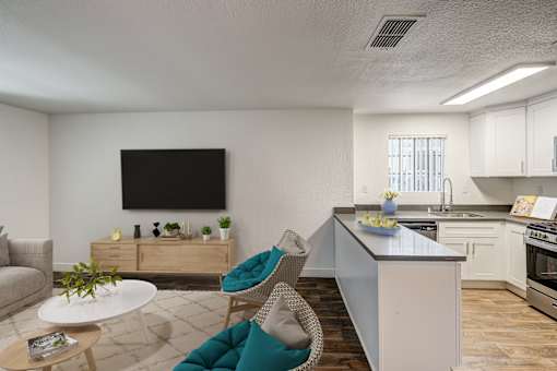 A modern kitchen with a white countertop and a blue chair.
