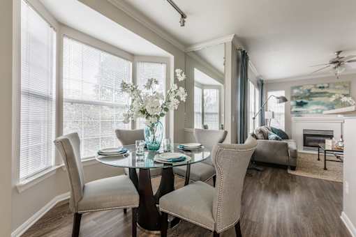 Dining room with glass table at The Retreat at Fox Hollow apartments for rent in Lakewood, CO.