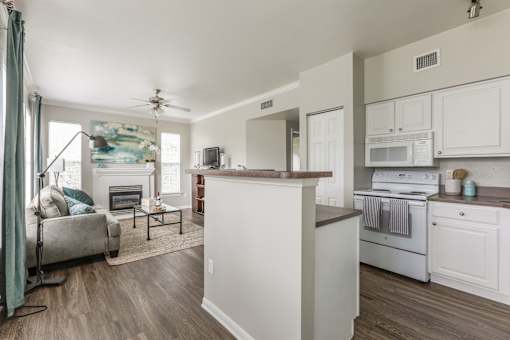 Modern kitchen with wooden island at The Retreat at Fox Hollow Lakewood, CO apartment.