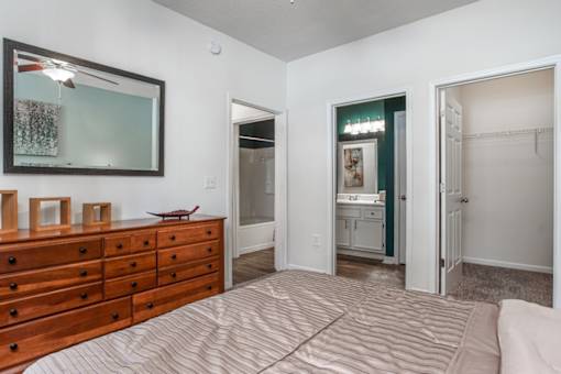 A bedroom with a dresser and a mirror.