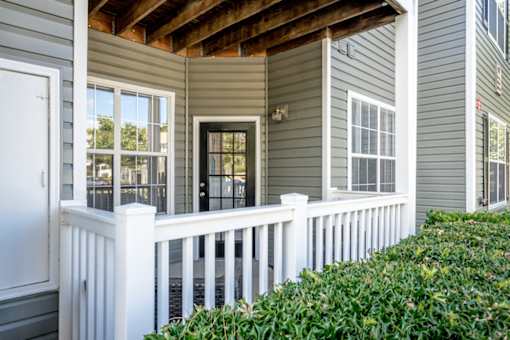 A house with a white fence and a black door.