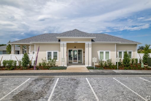 a large white house with a driveway and a front door