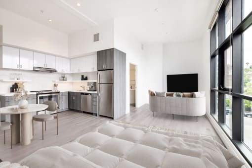 Living room with a couch and a table and a kitchen at Edendale Crossing, Echo Park, CA 90026