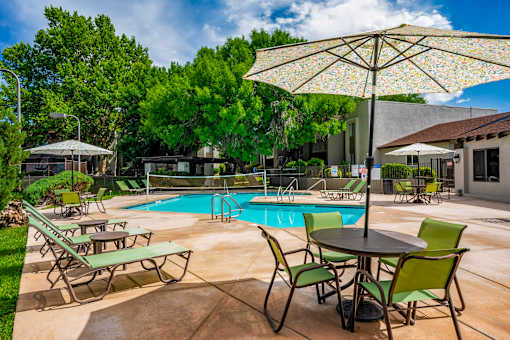 Poolside area with table and chairs at Eagle Point Apartments, Albuquerque