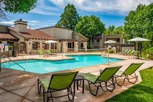 Pool surrounded by lounge chairs at Eagle Point Apartments, New Mexico, 87111