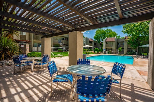 Patio with blue chairs at Eagle Point Apartments, New Mexico, 87111