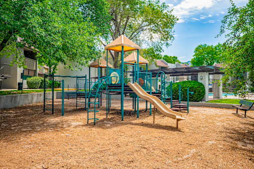 Playground with green slide at Eagle Point Apartments, Albuquerque, New Mexico