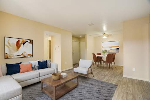 A living room with a white couch and a coffee table.