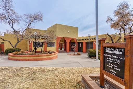 A sign in front of a building that says Estrada Pointe Apartments.