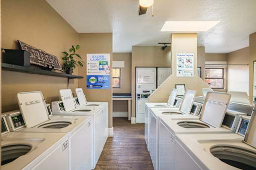 A laundromat with rows of washers and dryers.