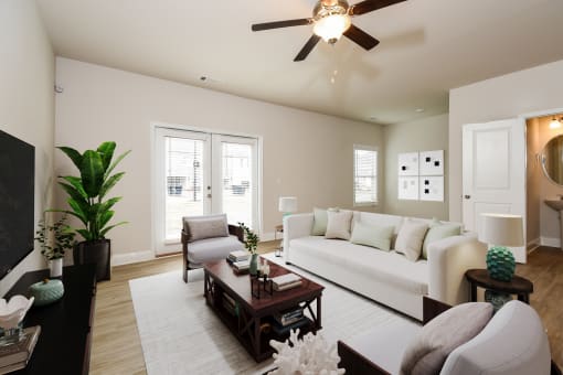 a living room with a white couch and a brown coffee table