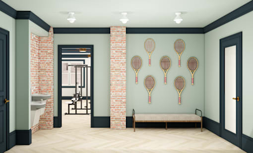A room with a bench and tennis rackets on the wall.