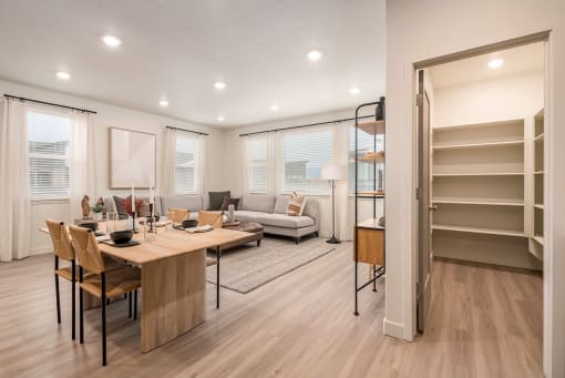 a living room and dining room with a table and chairs