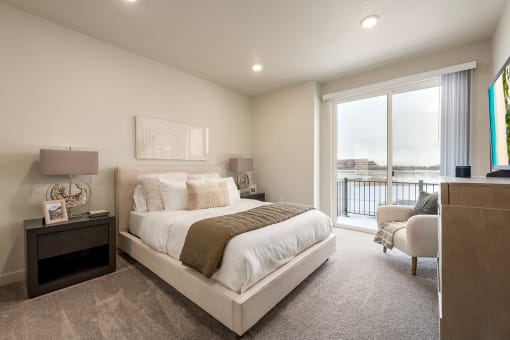 a master bedroom with a large bed and a window