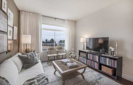 Ocean view living room at Eliot on Ocean with white couch, tv and coffee table