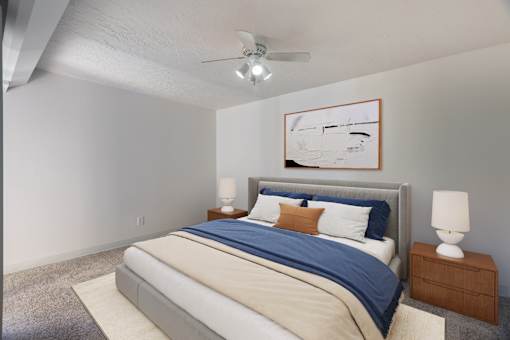 A bedroom with a bed, nightstand, and ceiling fan.