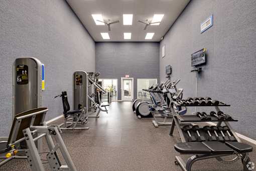 Fitness center with weight equipment and machines at Fusion Apartments, Orlando