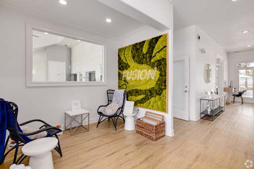 Entryway with moss wall art and seating area at Fusion Apartments, Orlando, 32818