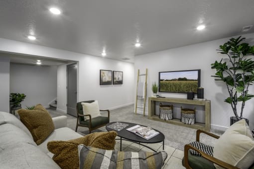 a living room with a couch and a coffee table and a television