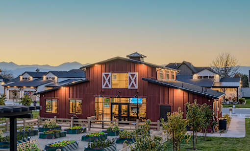 A barn-like building with a red and white exterior and a large X on the front.