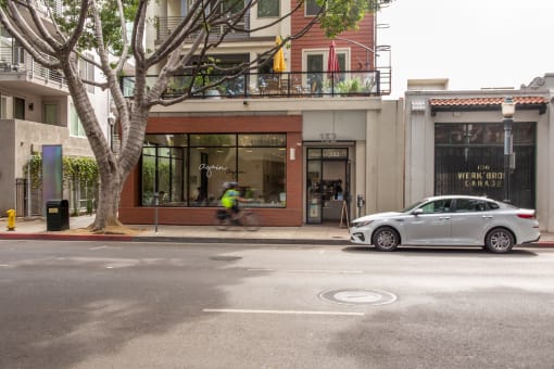 a car parked on the side of the road in front of a building