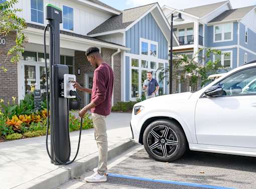 a man is charging his car at a gas pump