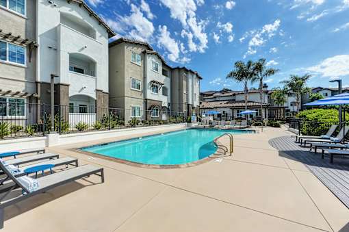 A swimming pool surrounded by apartment buildings.