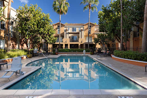 A pool with a reflection of a building in the water.