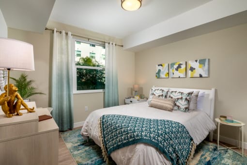 Bedroom with window at Aston at Gateway Apartments, California