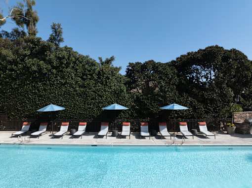 Pool with chairs and umbrellas next to a pool at Ascend2300, Carlsbad, CA, 92008