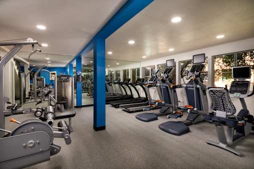 Gym with cardio equipment and weights in a building with windows at Ascend2300, Carlsbad, CA
