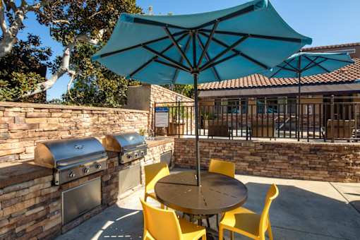 Patio with a table and chairs and an umbrella at Ascend2300, Carlsbad, CA, 92008