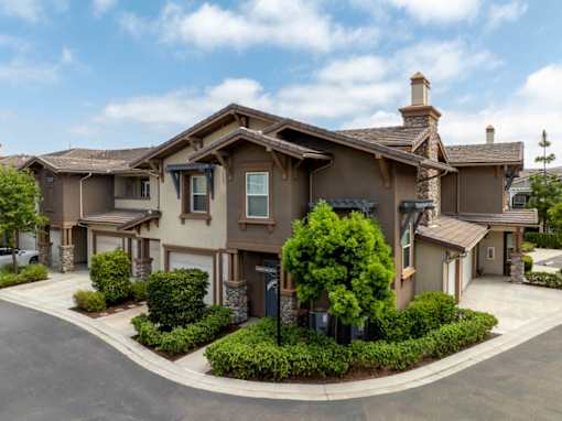 A large house with a driveway and a mailbox.