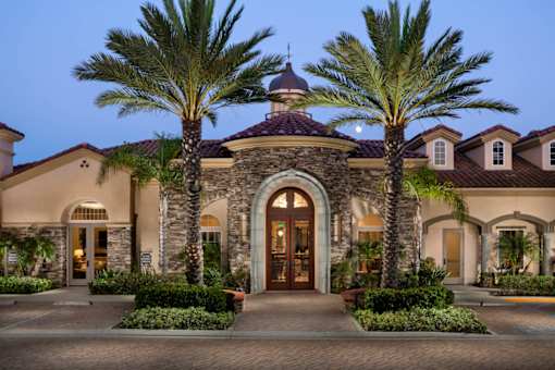 A large house with a brown roof and a stone archway entrance.
