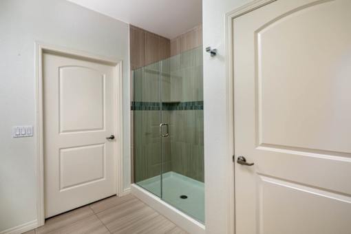 A white door is on the left and a glass door is on the right.
